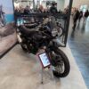Eine Royal Enfield Himalayan 450 Mana Black auf einem Messestand der Intermot 2025 in Köln